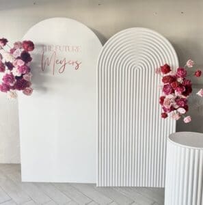 Arch backdrops with pink and red flower arrangements